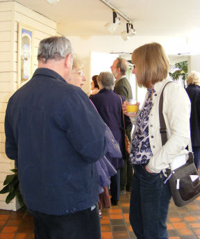 Invited guests at the Opening Weekend, admiring the paintings, chatting and enjoying the buffet